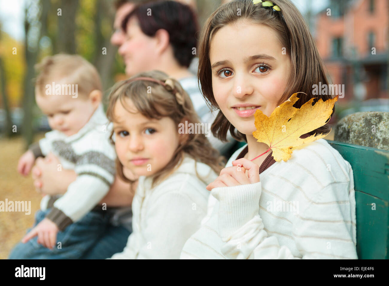 Happy family in the autumn park Stock Photo - Alamy