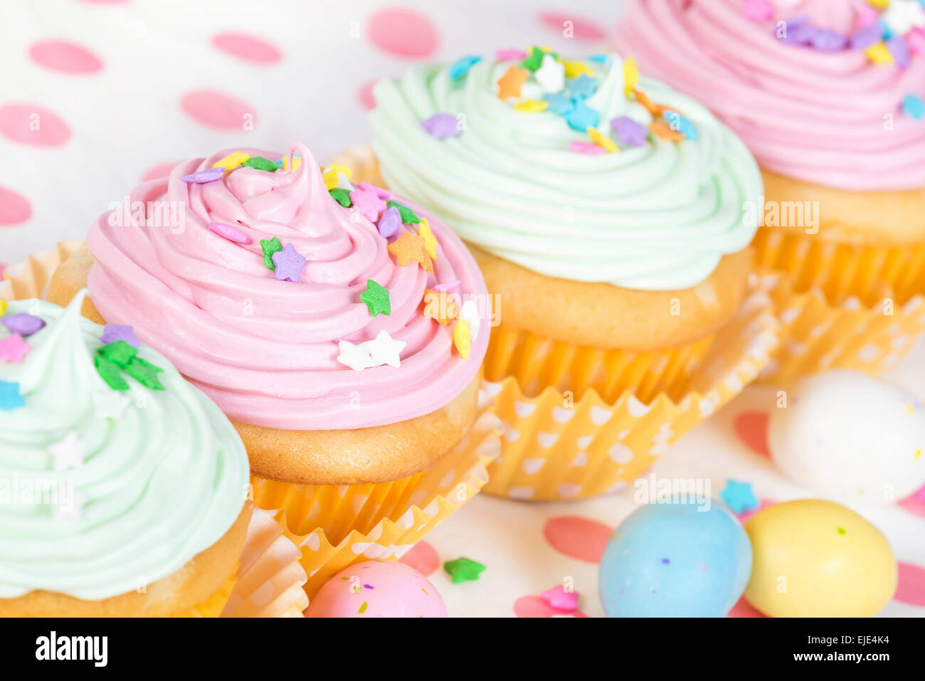 Pastel Easter cupcakes with candy and sprinkles Stock Photo Alamy