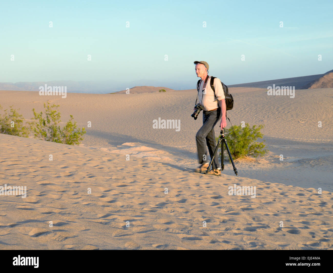 Photographer treks through the dunes in Death Valley National Park Stock Photo