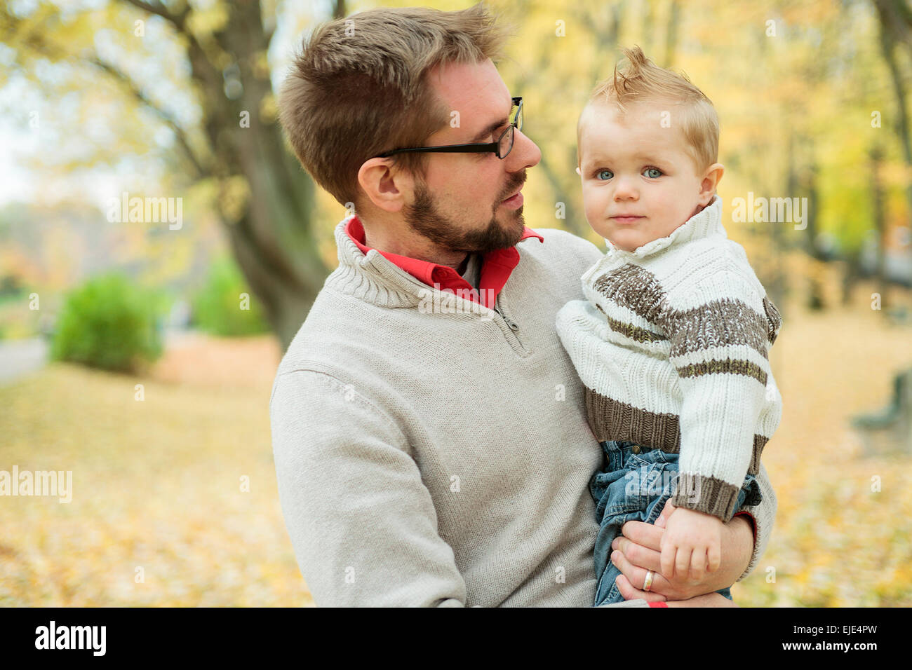 Father and son playing in a beautiful autumn park Stock Photo - Alamy