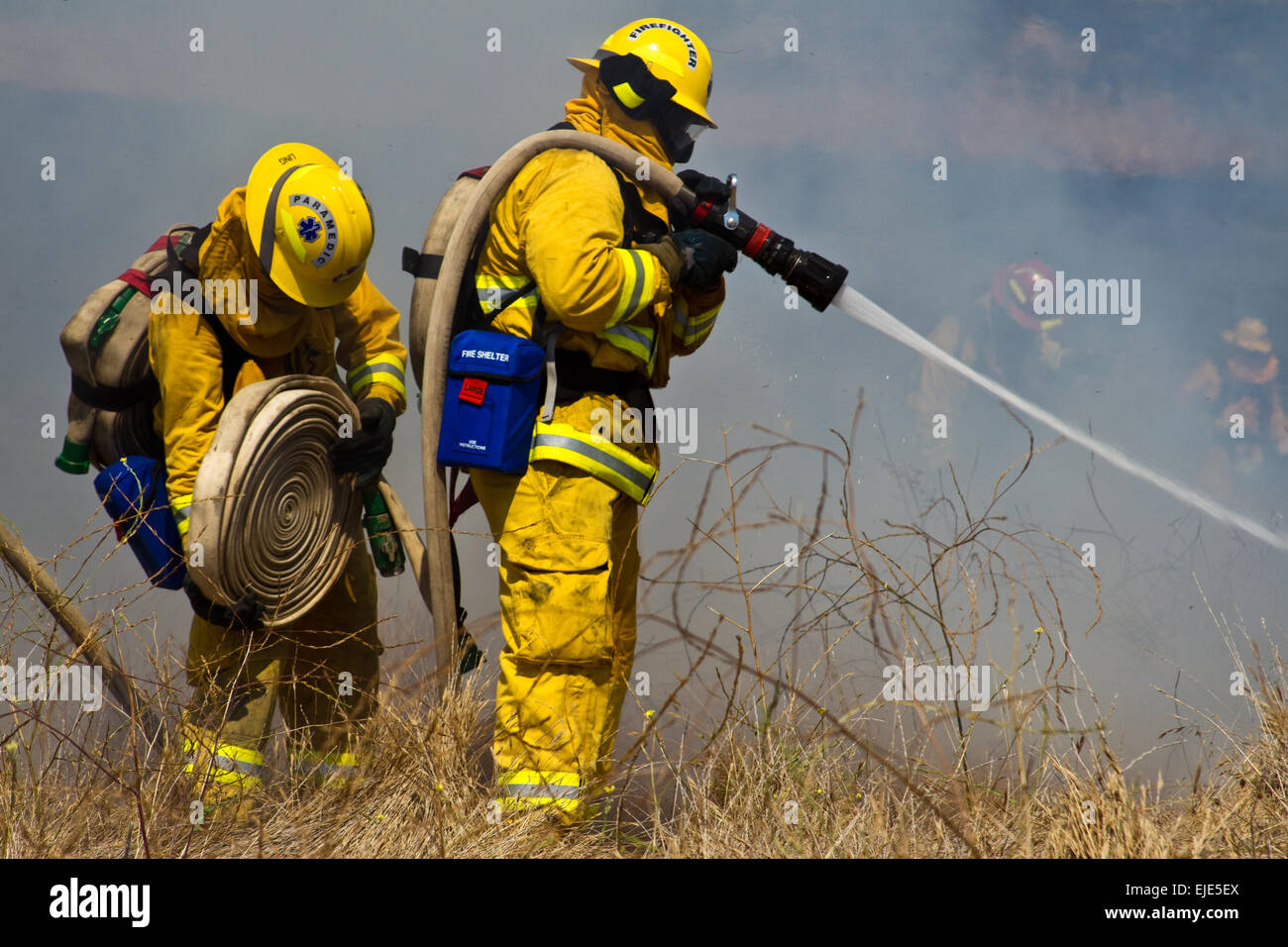 Firefighter Fighting Fire Stock Photo