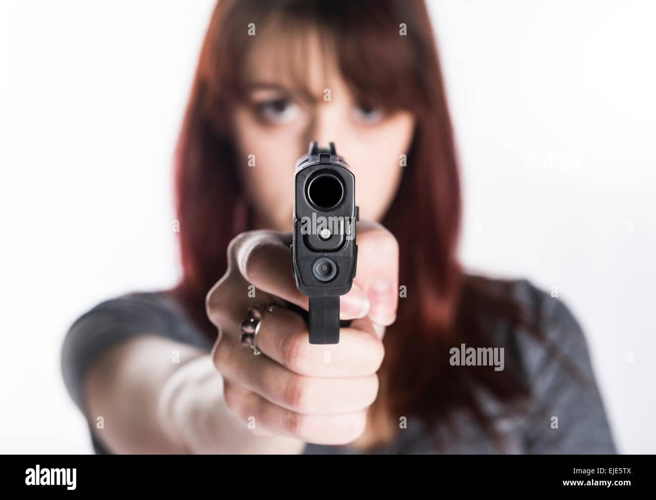Young Woman Pointing a Gun at the Camera Stock Photo - Alamy