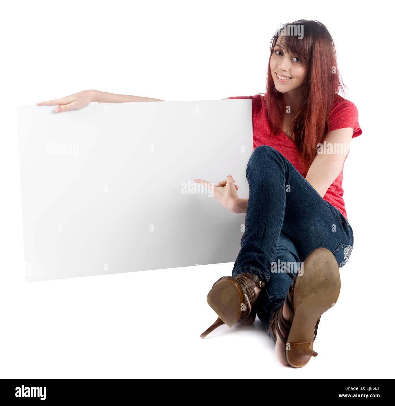Sitting Woman Pointing at her Empty Cardboard Stock Photo