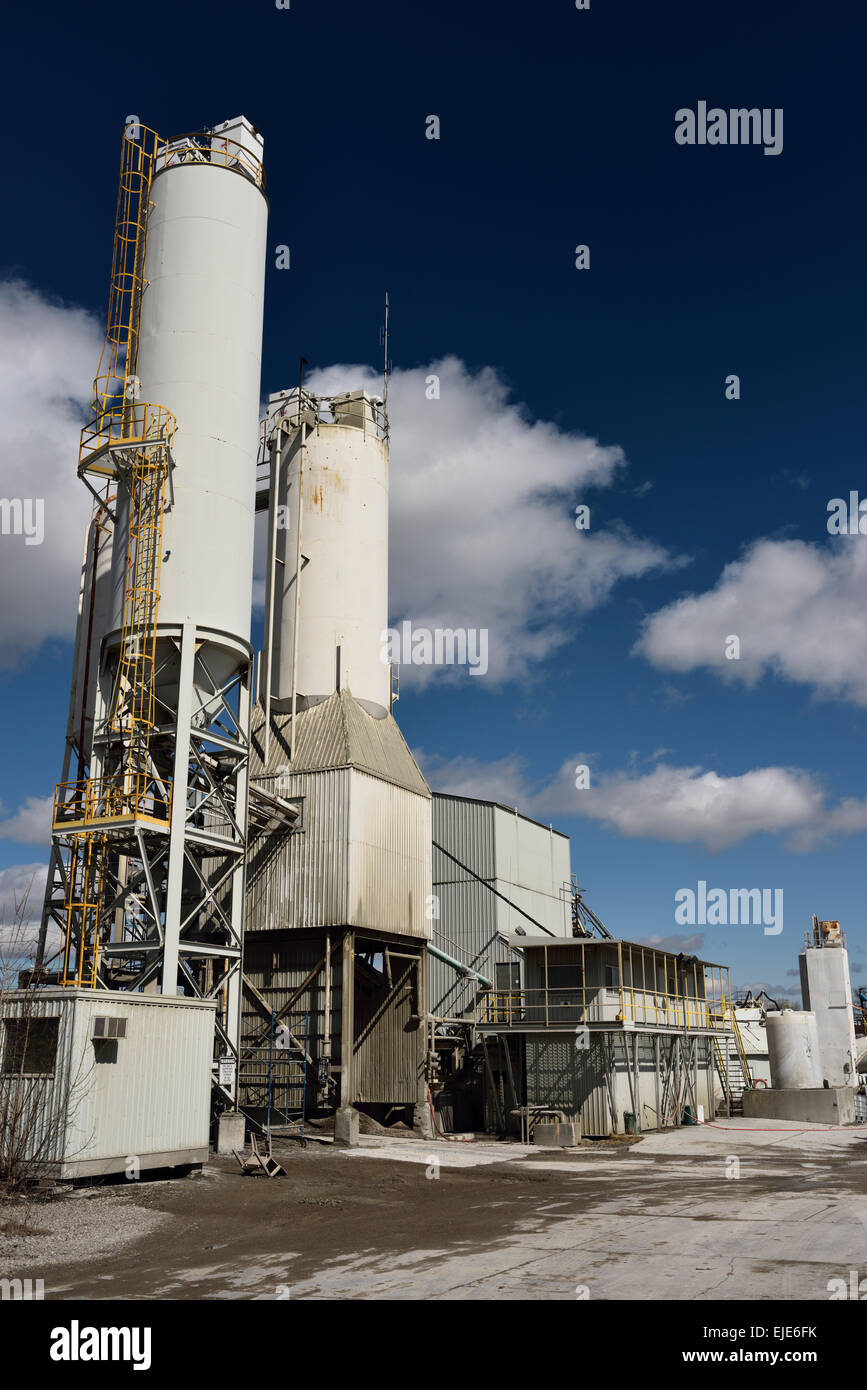 Portland cement plant with ground clinker silos with blue sky Toronto Stock Photo