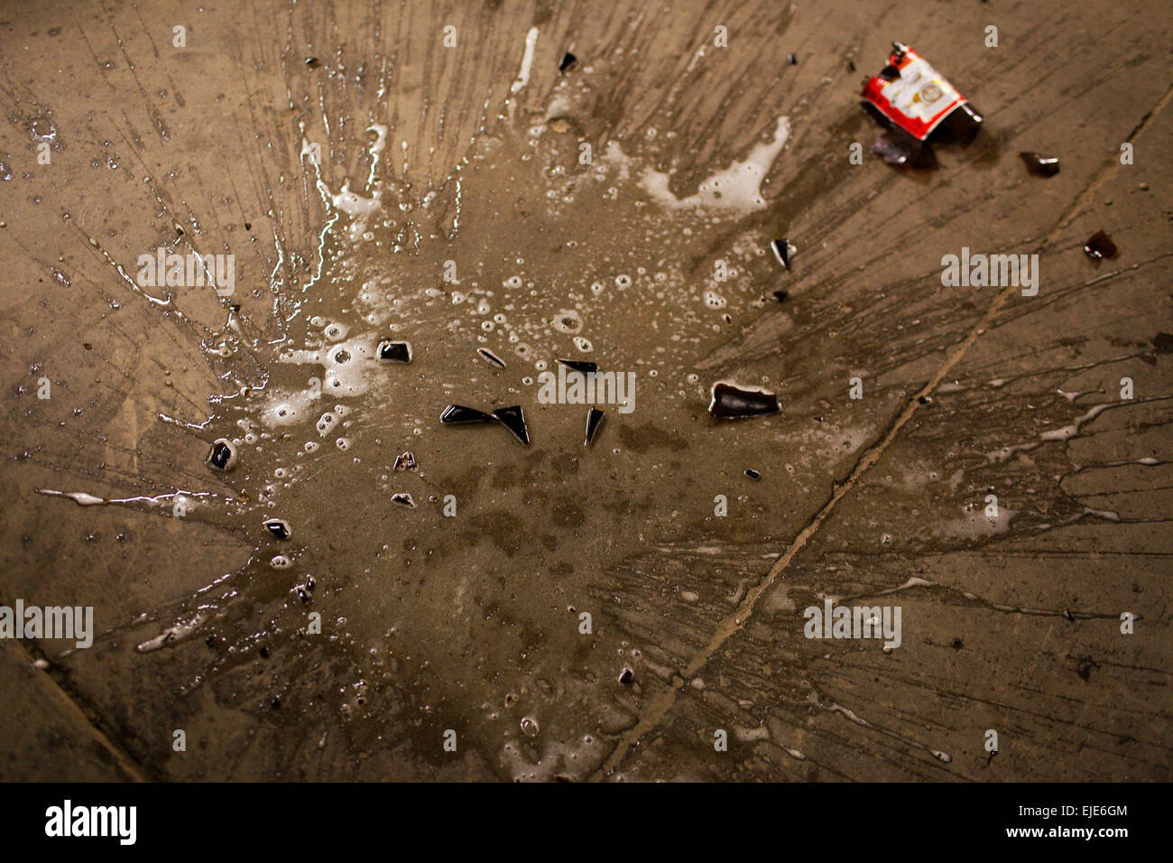 a-broken-40-oz-beer-on-the-floor-of-a-garage-EJE6GM.jpg