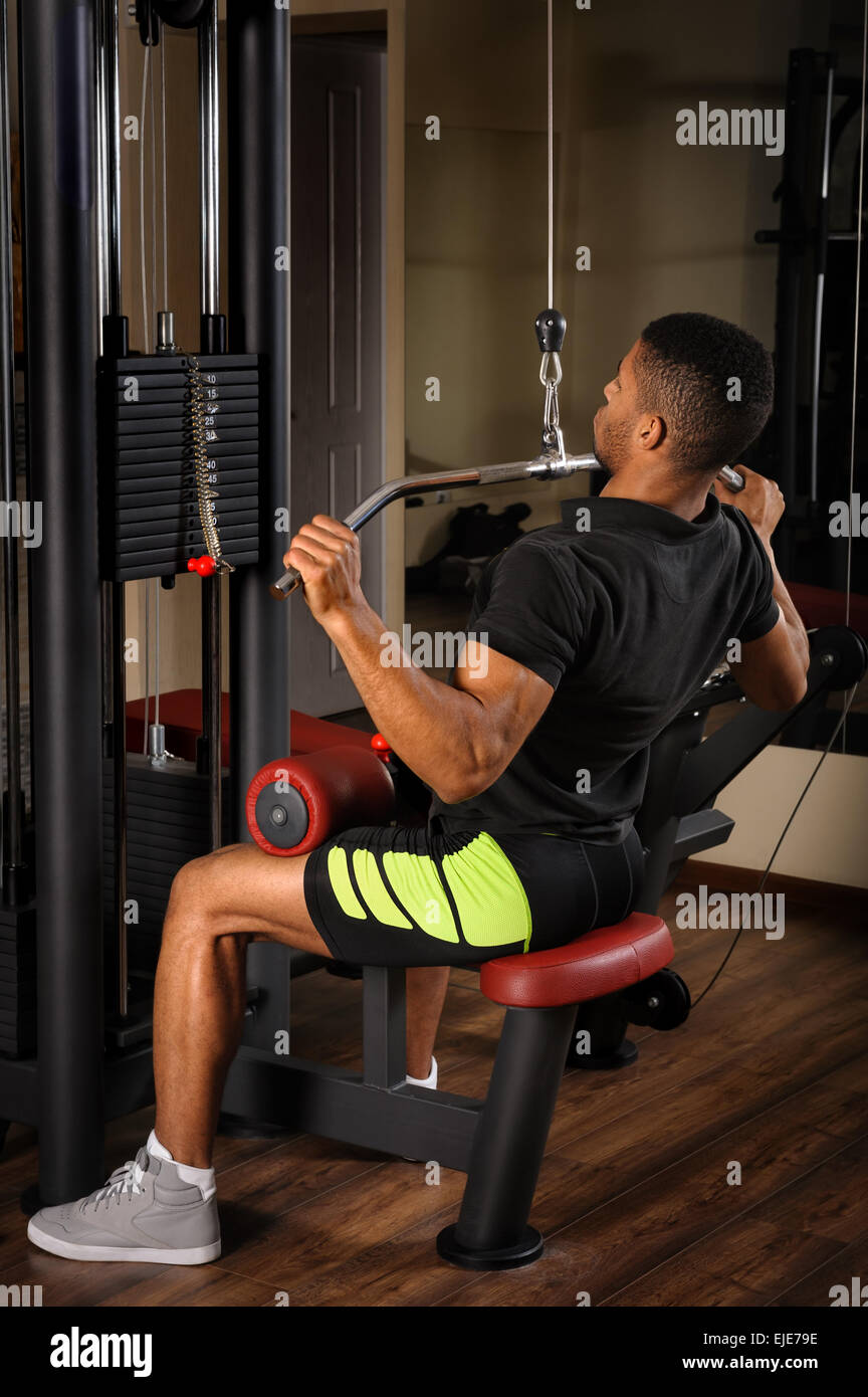 Young man doing lats pulldown workout Stock Photo Alamy