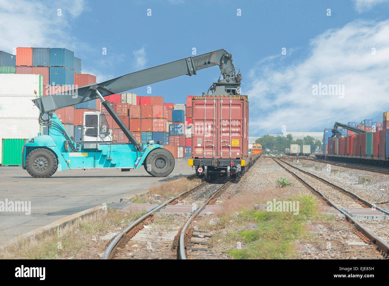 forklift handling container box loading to freight train Stock Photo