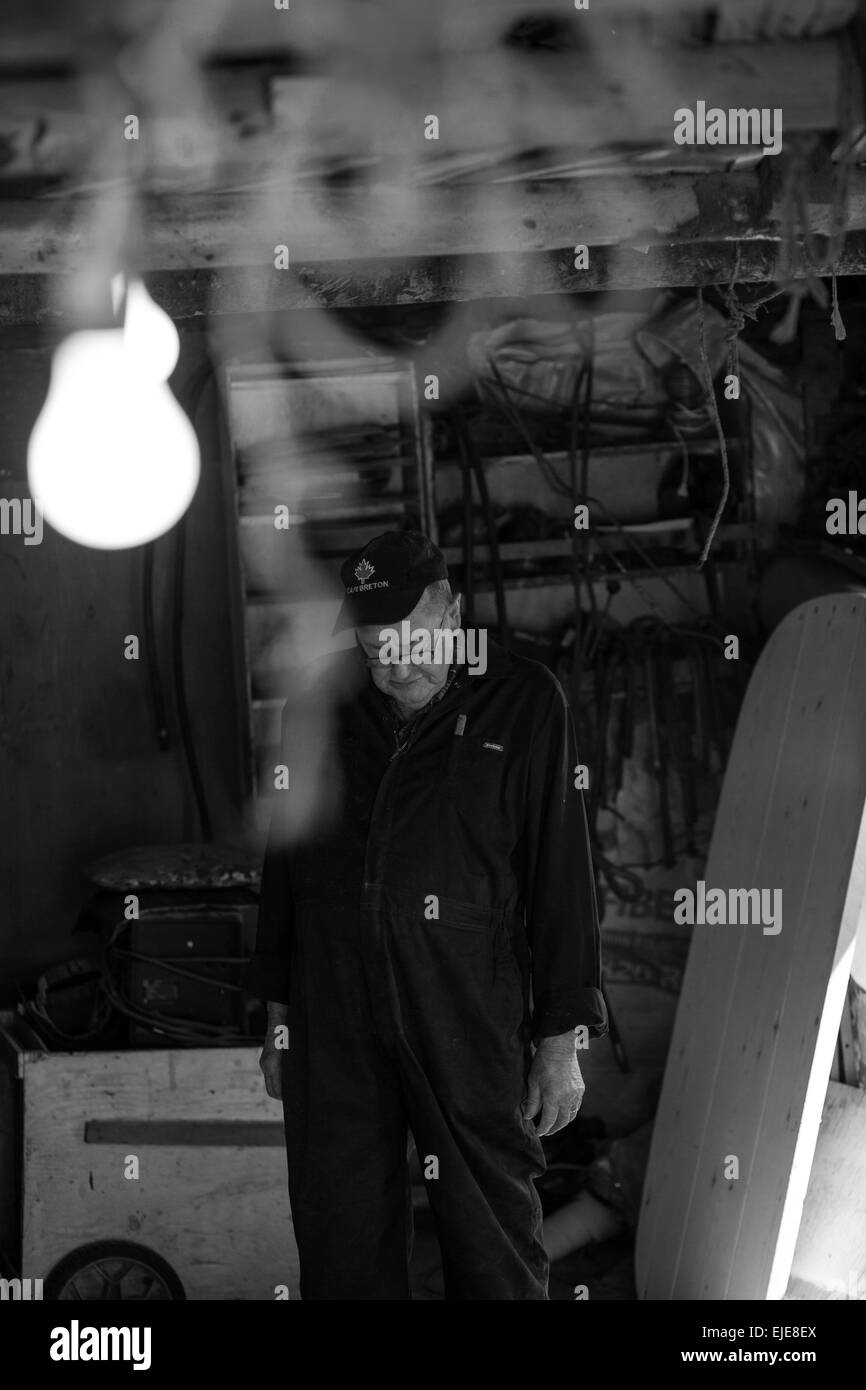 Patsy Christie of Englishtown, Nova Scotia constructs what will be his last wooden boat. Stock Photo