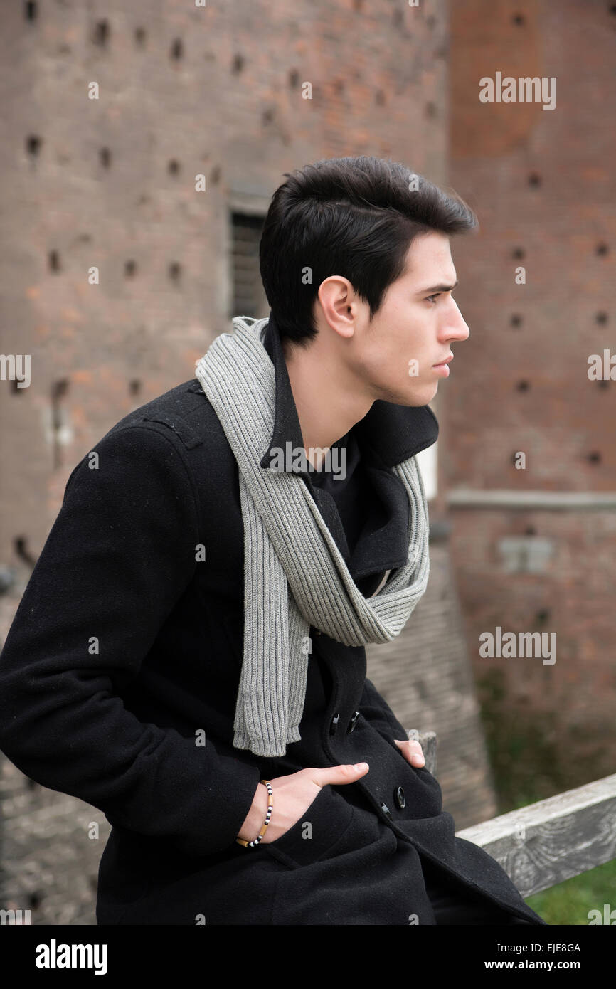 Close up Stylish Young Handsome Man Outside Old Building, looking to the Right of the Frame. Stock Photo