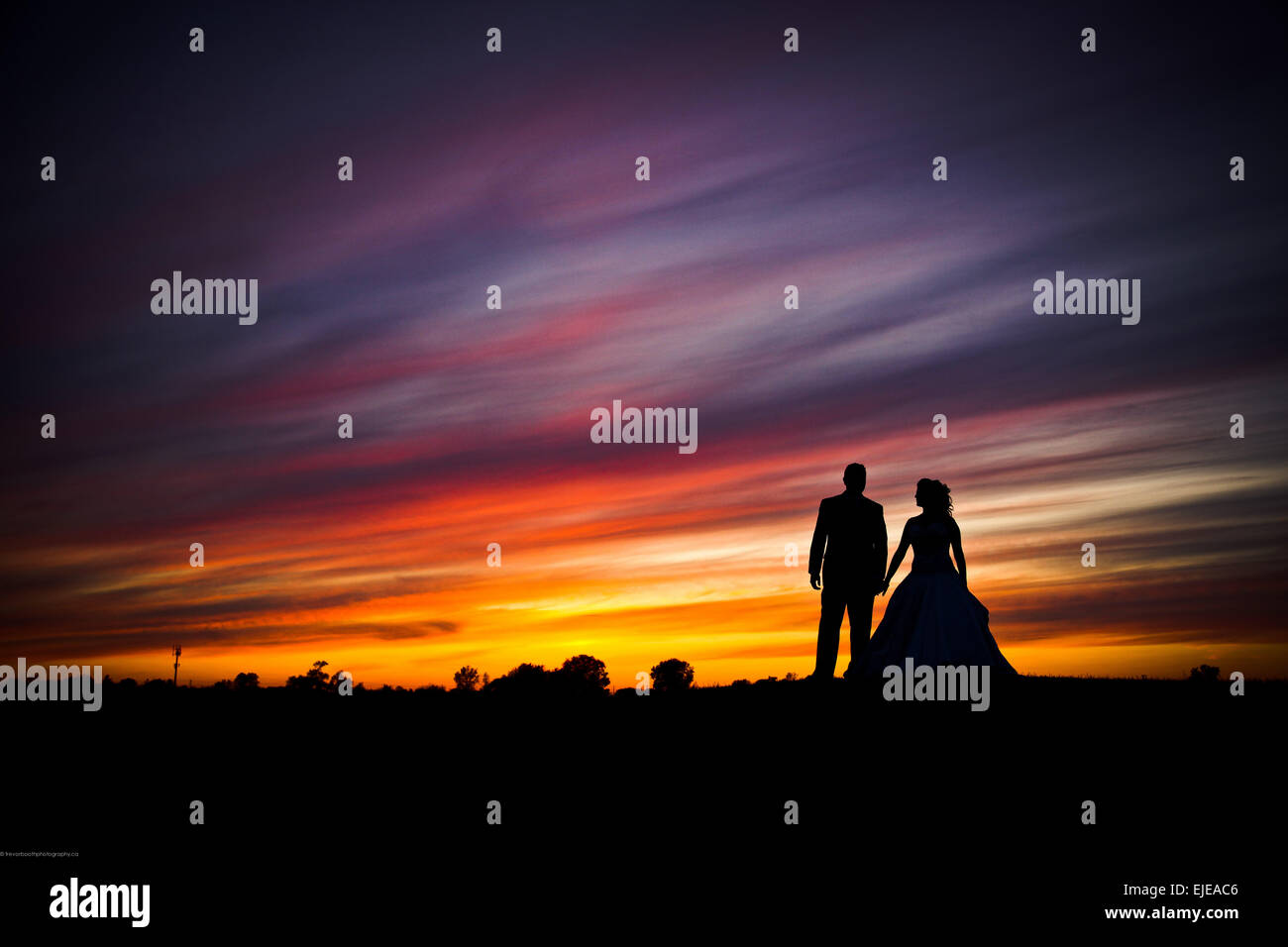 bride and groom at sunset Stock Photo - Alamy