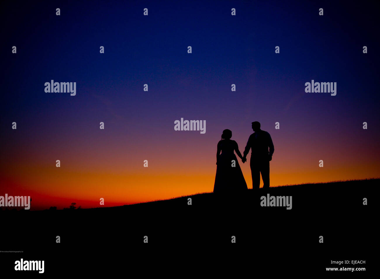 bride and groom at sunset Stock Photo - Alamy