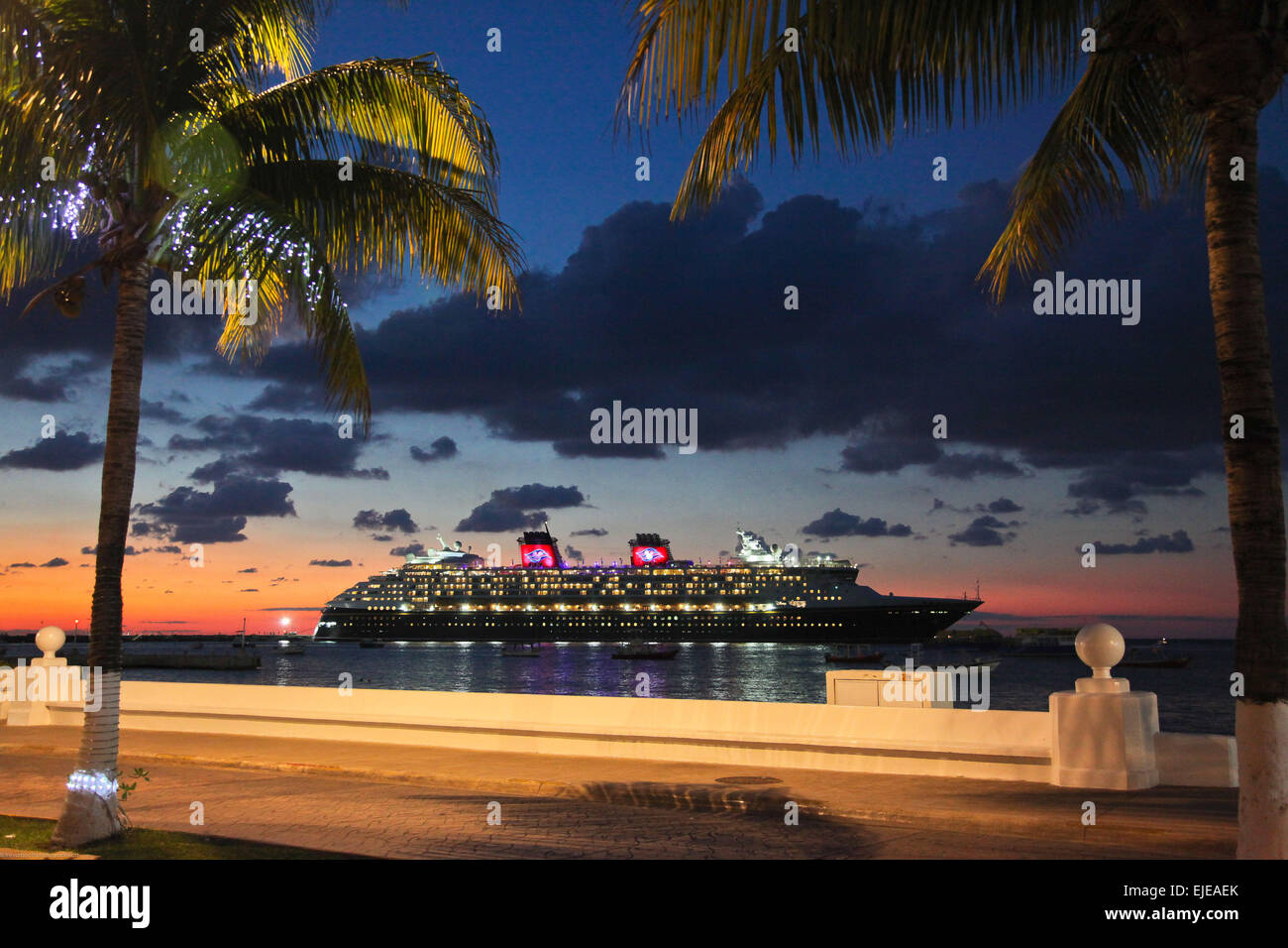 Disney Cruise ship docked in Cozumel Mexico, ready to set sail at sunset Stock Photo