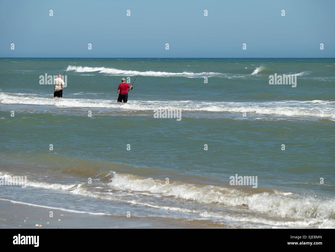 Two men surf fishing in February at South Padre Island, Texas, USA Stock Photo