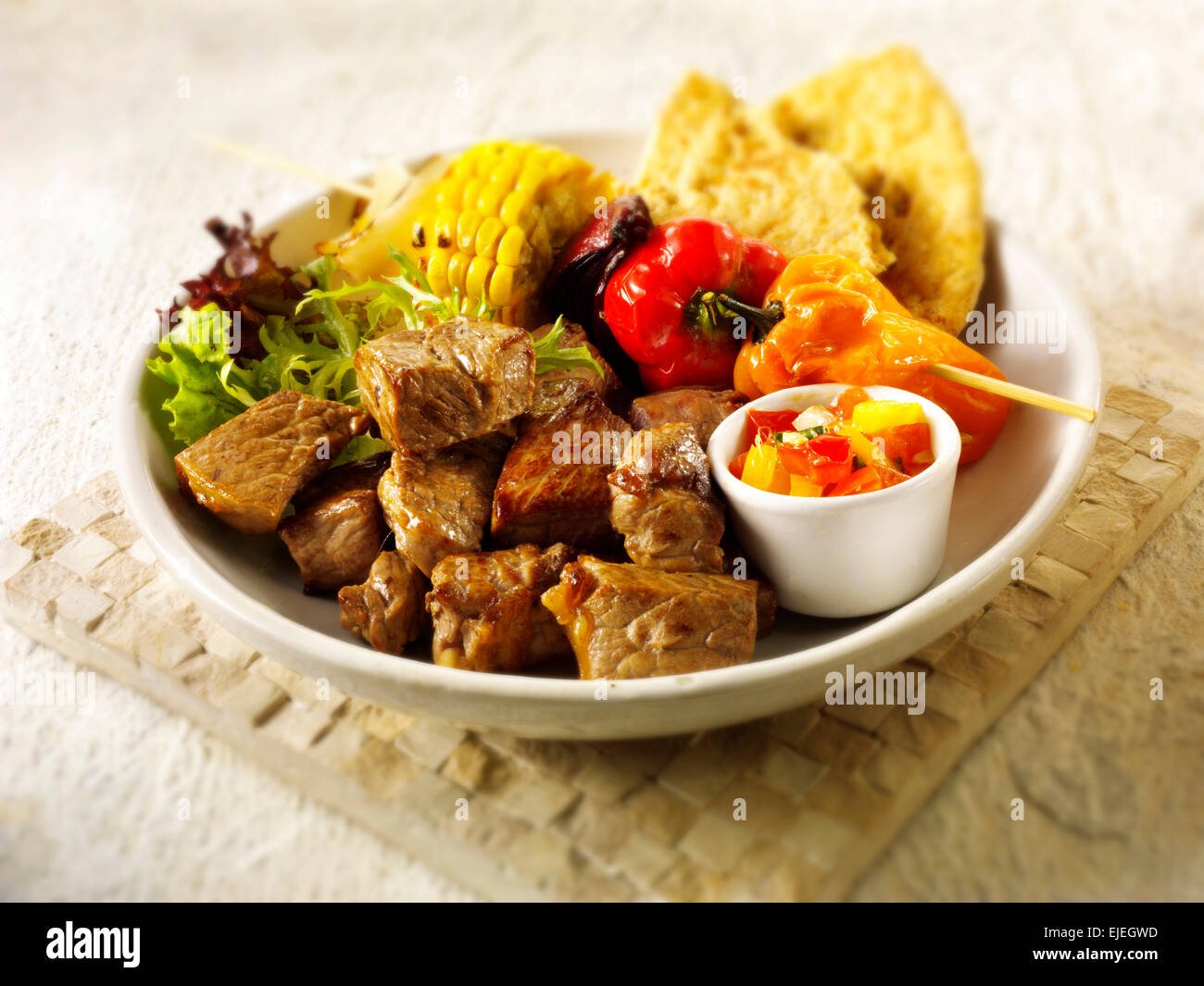 Barbecue beef steak brochettes and vegetables Stock Photo