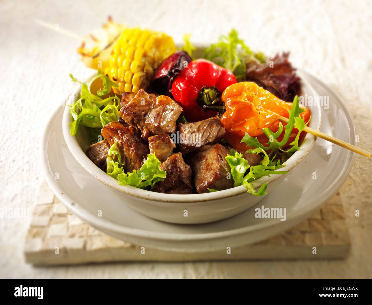 Barbecue beef steak brochettes and vegetables Stock Photo