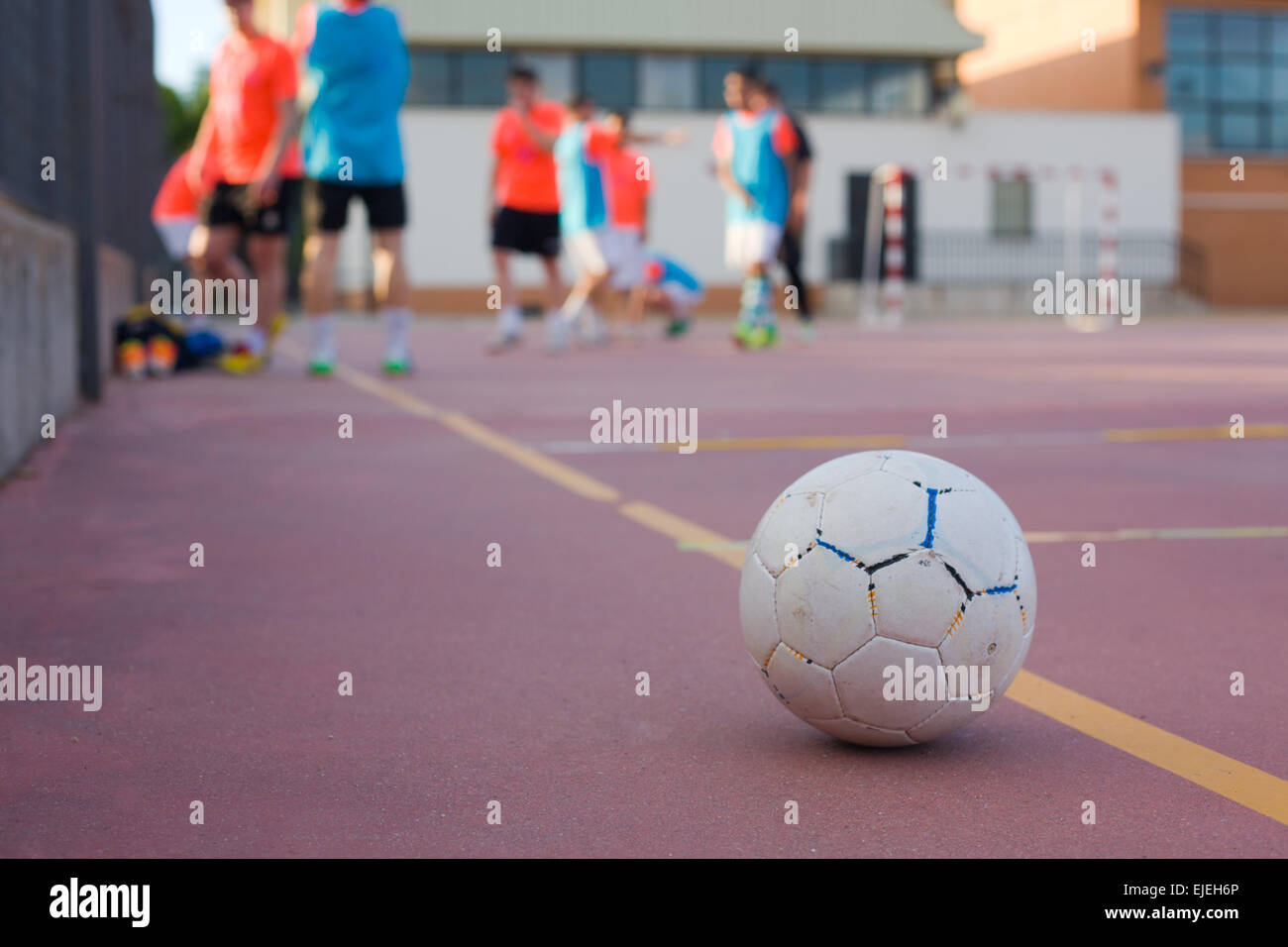 5 a side football team training over outdoors red court Stock Photo