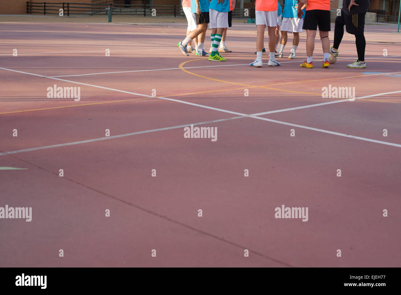 5 a side football team training over outdoors red court Stock Photo