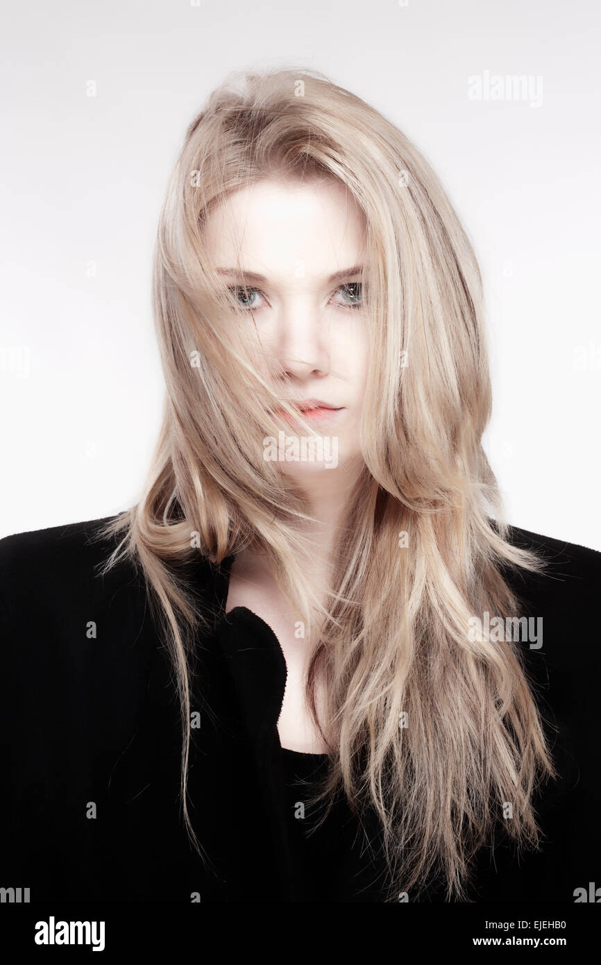 Portrait of a Young Woman with Blond Hair and Black Coat Stock Photo
