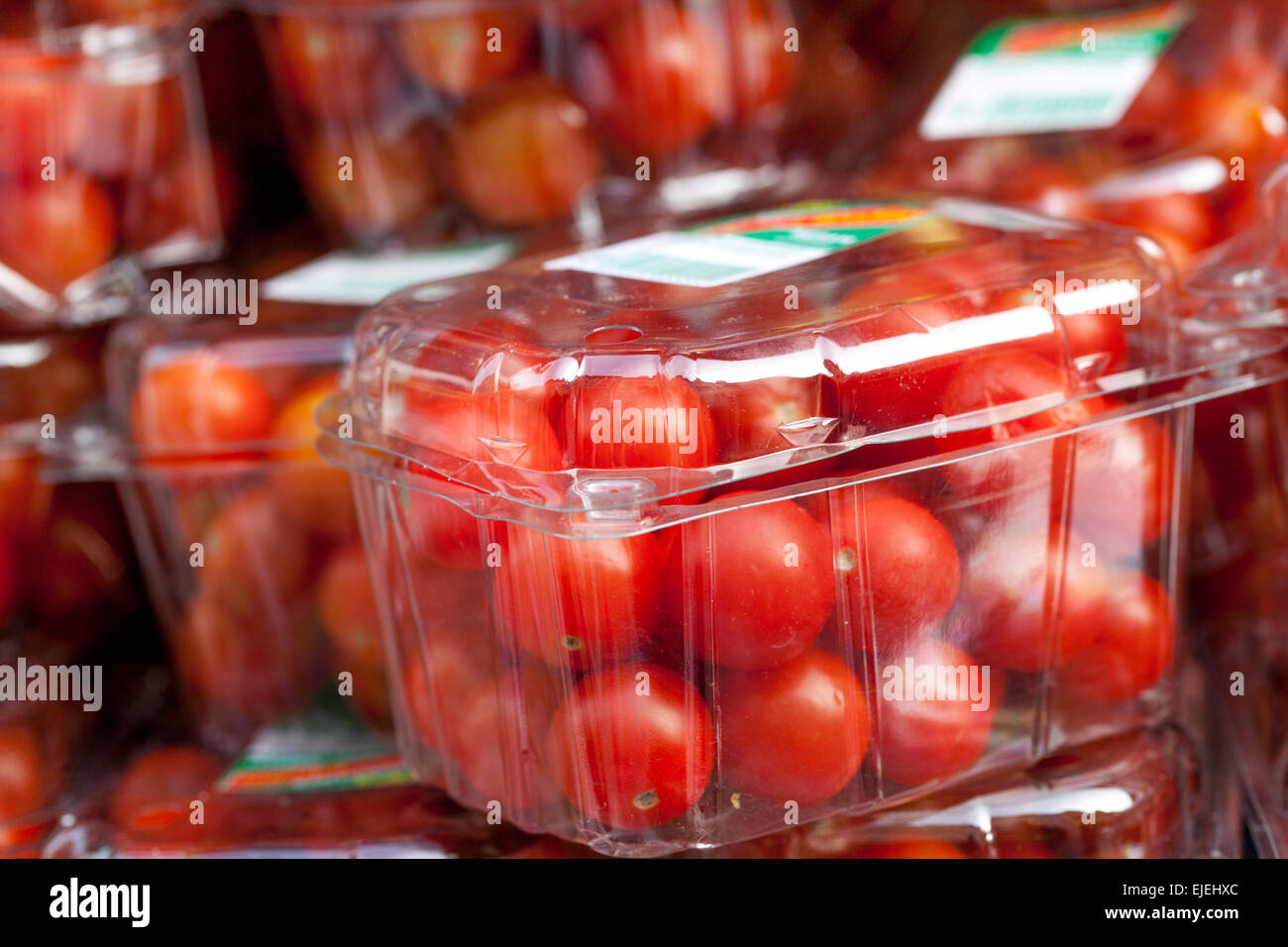 Tomatoes -  in a plastic box on market Stock Photo