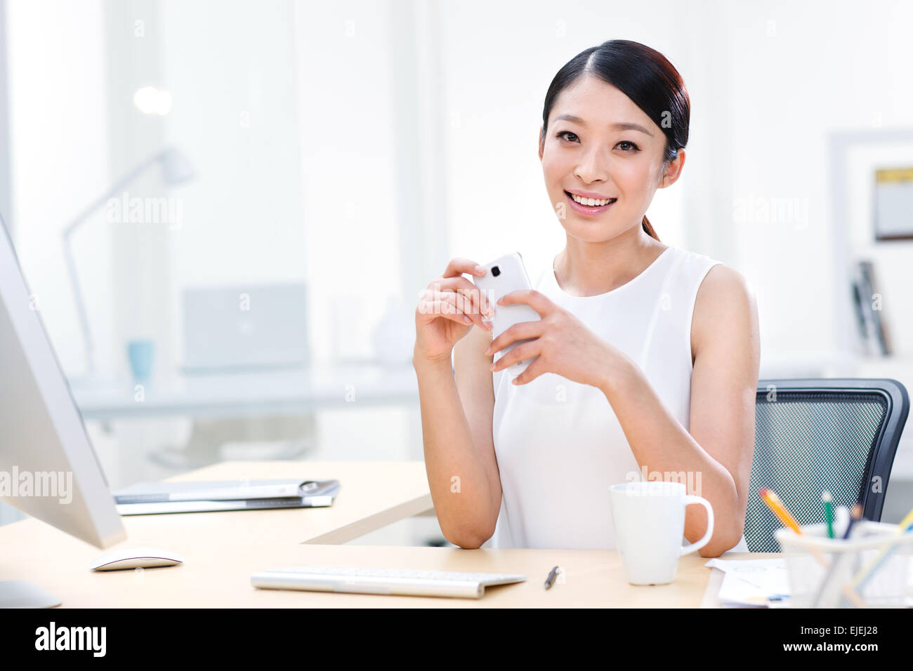 Young business lady sitting in the office Stock Photo - Alamy