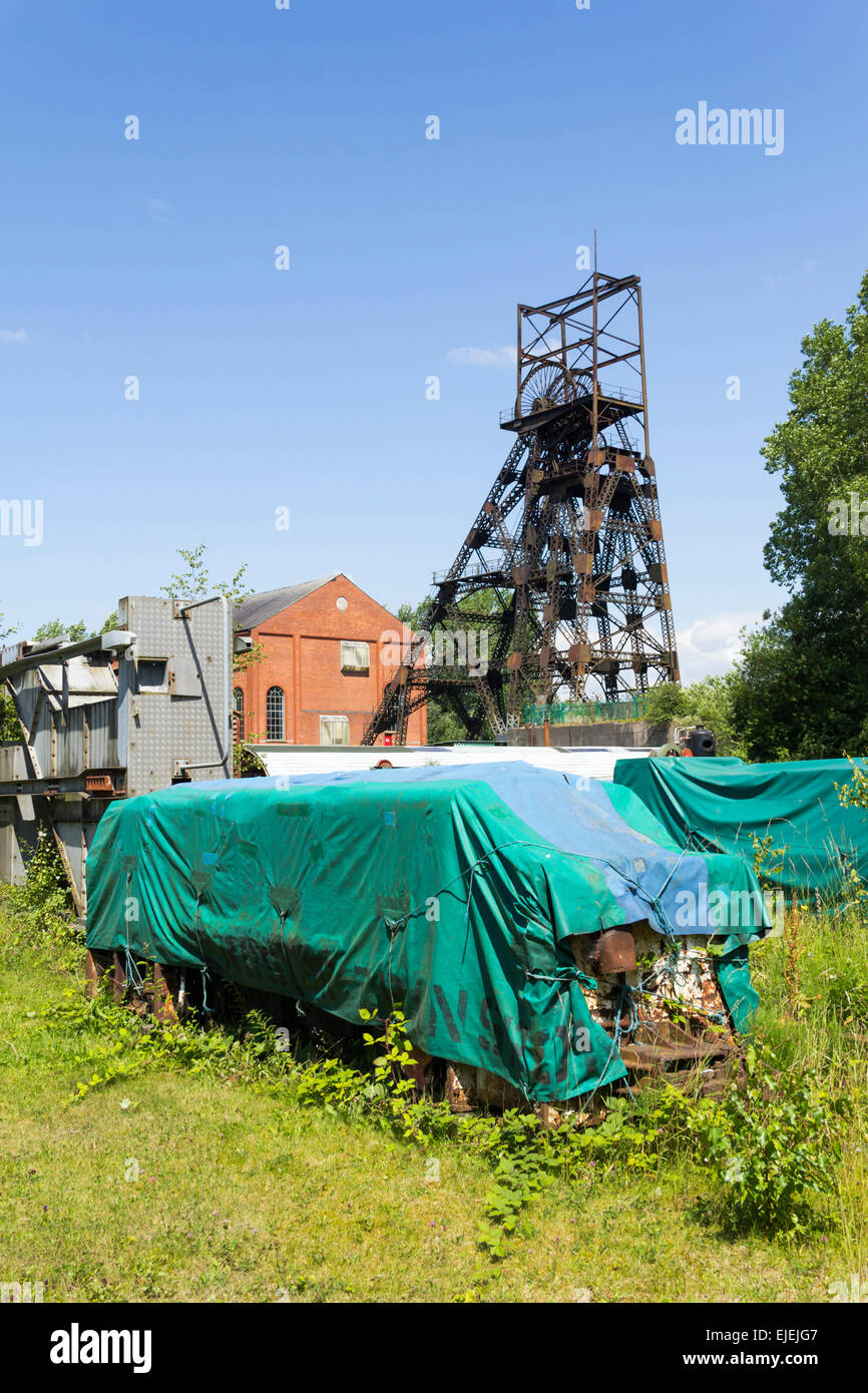 Sheeted scrap internal narrow gauge railway wagons awaiting restoration work at Astley Green Colliery Museum near Manchester. Stock Photo