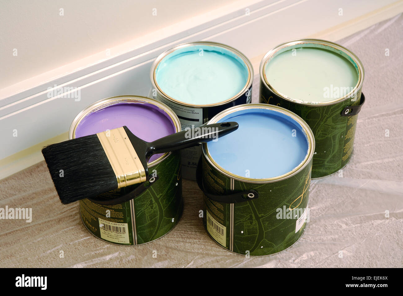 Four cans of paint in shades of blue, purple, and green Stock Photo - Alamy