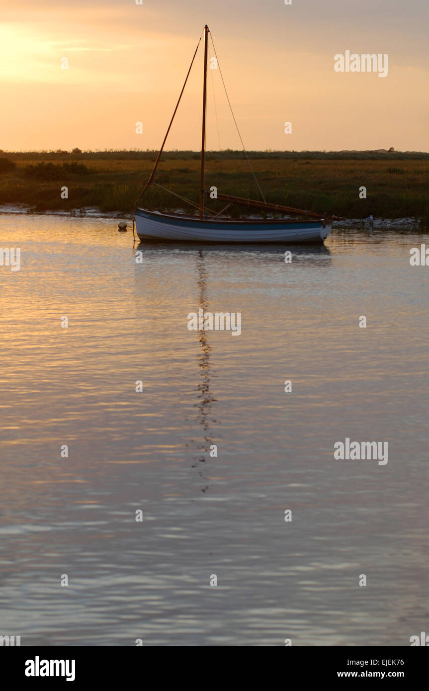 A fishing boat on calm water near a bank Stock Photo - Alamy