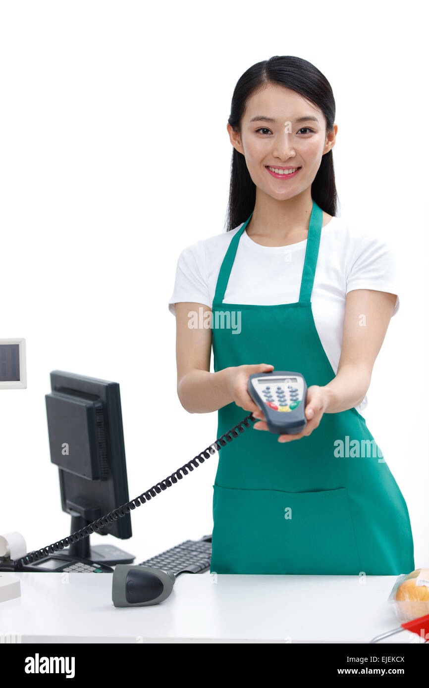 A female cashier holds POS machine Stock Photo