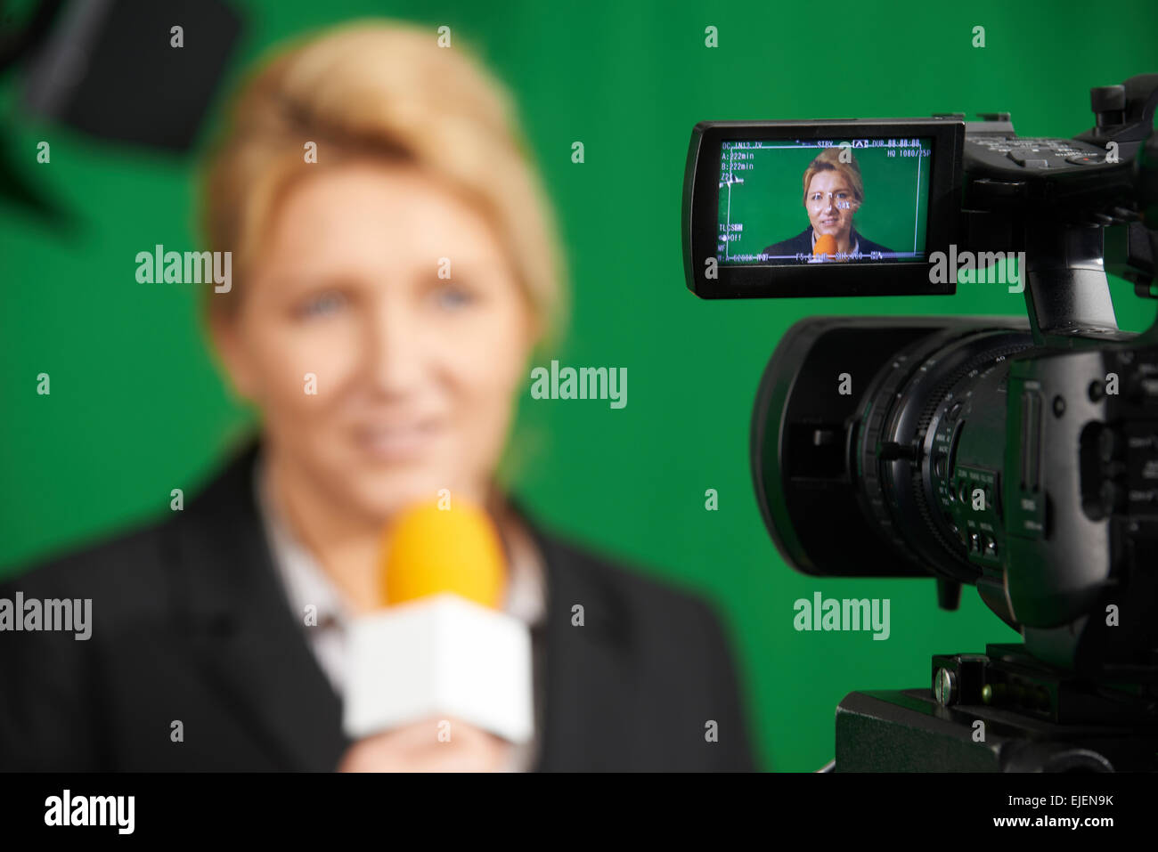 Female Journalist Presenting Report In Television Studio Stock Photo