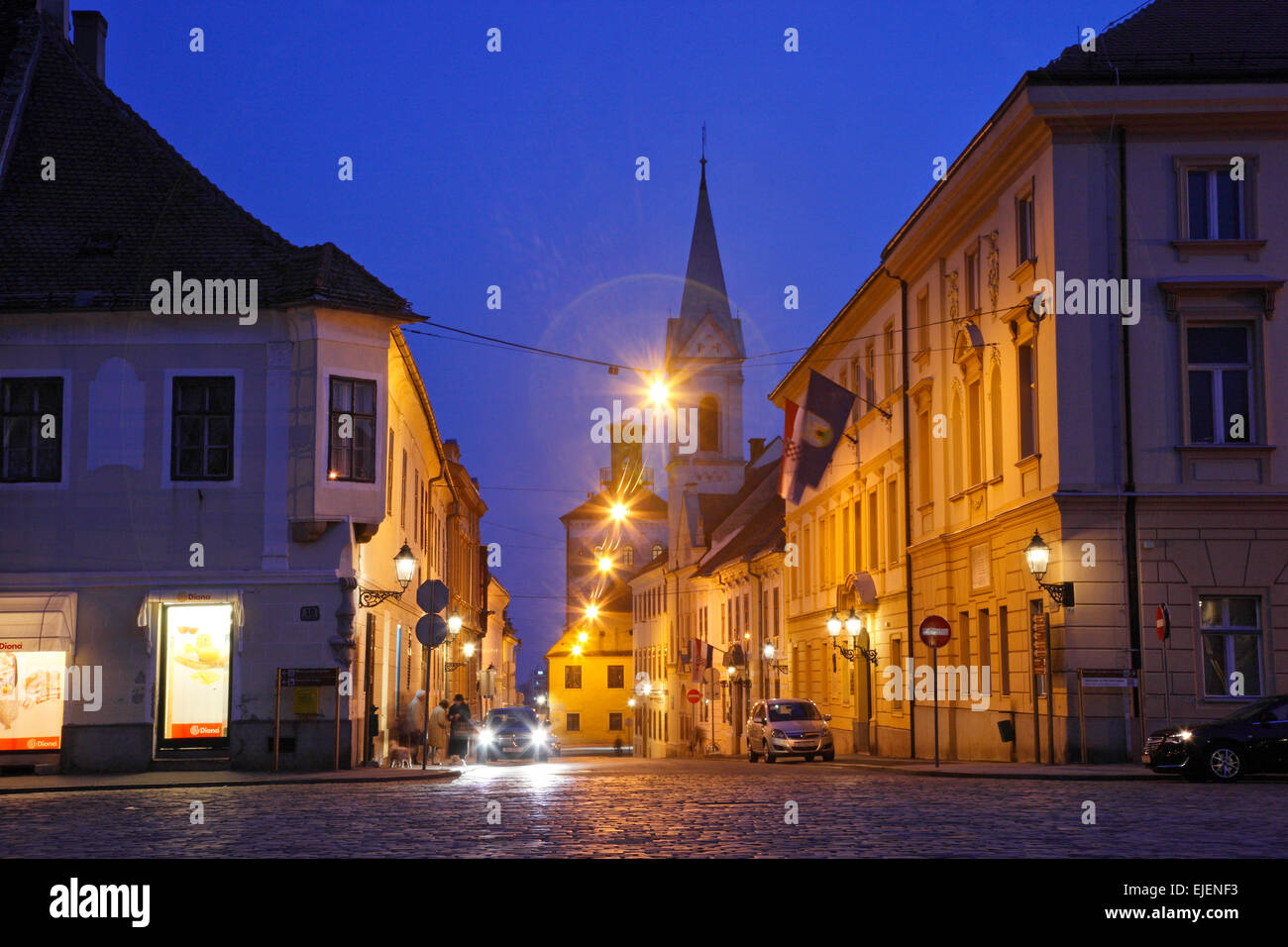 Zagreb, upper town by night. Church and Lotrscak tower on the right. Popular tourists route. Stock Photo
