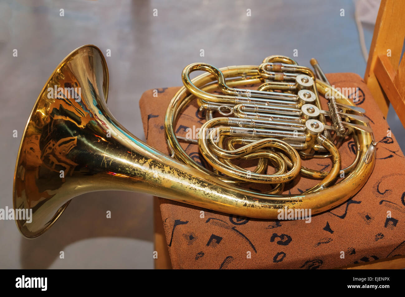 The French horn on a chair on a floor Stock Photo Alamy