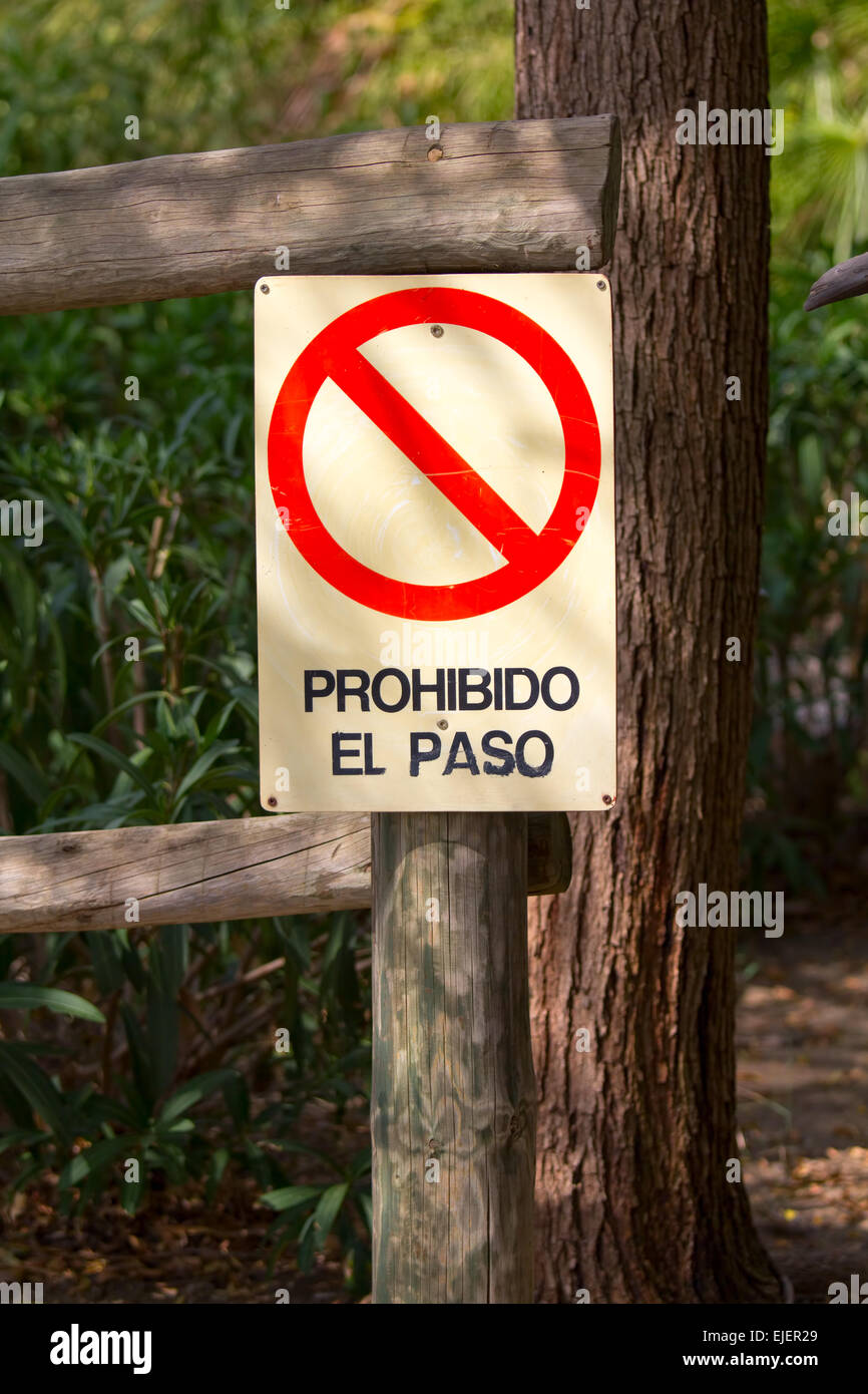 Prohibition sign in spanish on a wooden post in the countryside. Prohibido el paso, Forbidden pass Stock Photo