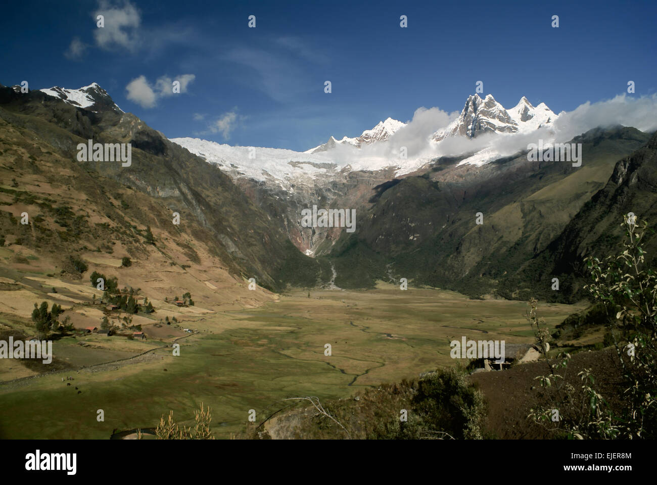 Scenic green valley in between high peaks of mountains in Peruvian Andes Stock Photo