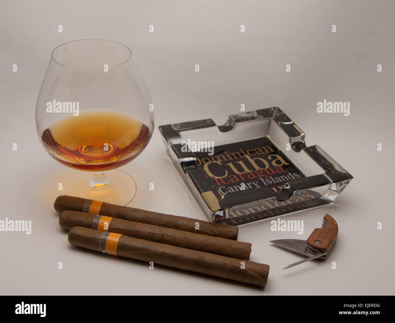 still life glass of brandy and Cuban cigars Stock Photo