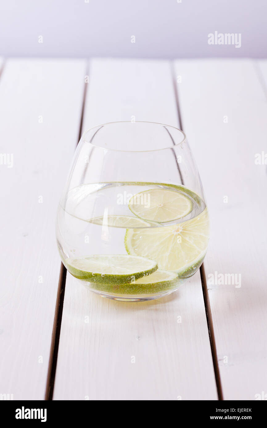 refreshing glas of water with slices of lime Stock Photo