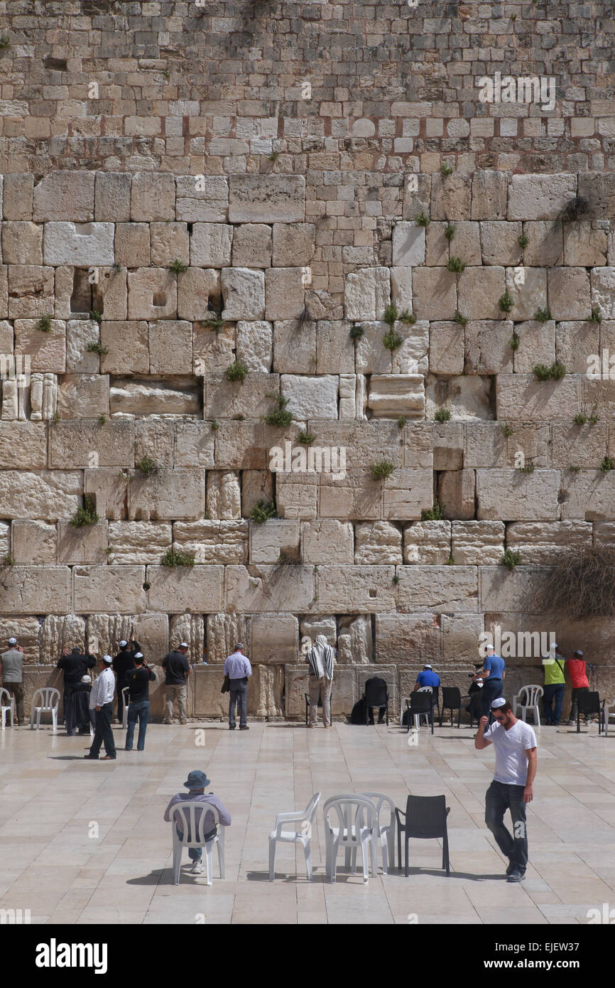Local People and tourists pray at the western wall. The western wall is