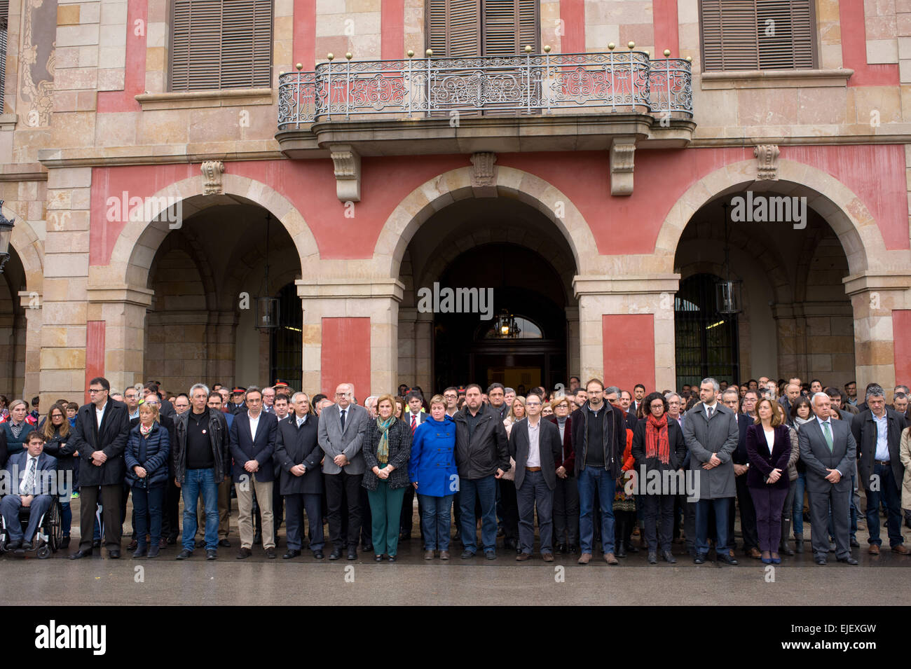 March 25, 2015 - Barcelona, Spain. Catalan parliamentarians during a moment of silence in front of the Catalan Parliament in mourning for the victims of the plane crash in the French Alps. The President of the Generalitat, Artur Mas, has decreed three days of official mourning for the victims in Catalonia traveling on the plane of the German company Germanwings that crashed in the French Alps when it was the journey between Barcelona and Dusseldorf. Stock Photo