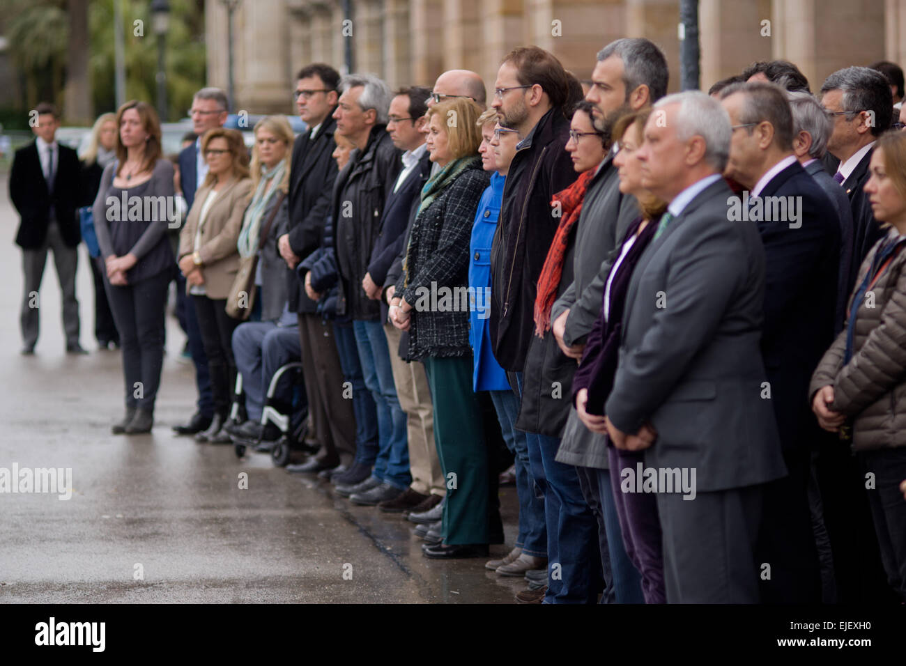 March 25, 2015 - Barcelona, Spain. Catalan parliamentarians during a moment of silence in front of the Catalán Parliament in mourning for the victims of the plane crash in the French Alps. The President of the Generalitat, Artur Mas, has decreed three days of official mourning for the victims in Catalonia traveling on the plane of the German company Germanwings that crashed in the French Alps when it was the journey between Barcelona and Dusseldorf. Stock Photo