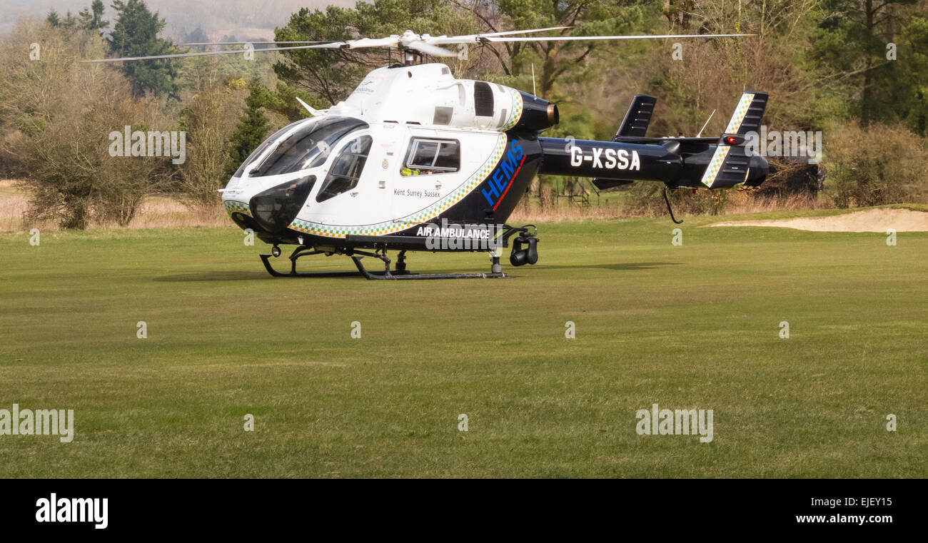 Surrey, UK. 24th Mar, 2015. The Kent, Surrey and Sussex Air Ambulance arrived at Effingham Golf Club near Guildford, Uk at about 10 o'clock on Wednesday morning 25th March 2015. A player had been taken ill whilst out for a game on a sunny morning. The Club's own First Aiders were able to give assistance whilst awaiting the arrival of the paramedics by road prior to the Air Ambulance getting to the scene. The Air Ambulance operates two MD902 Explorer helicopters. Credit:  Graham Johns/Alamy Live News Stock Photo