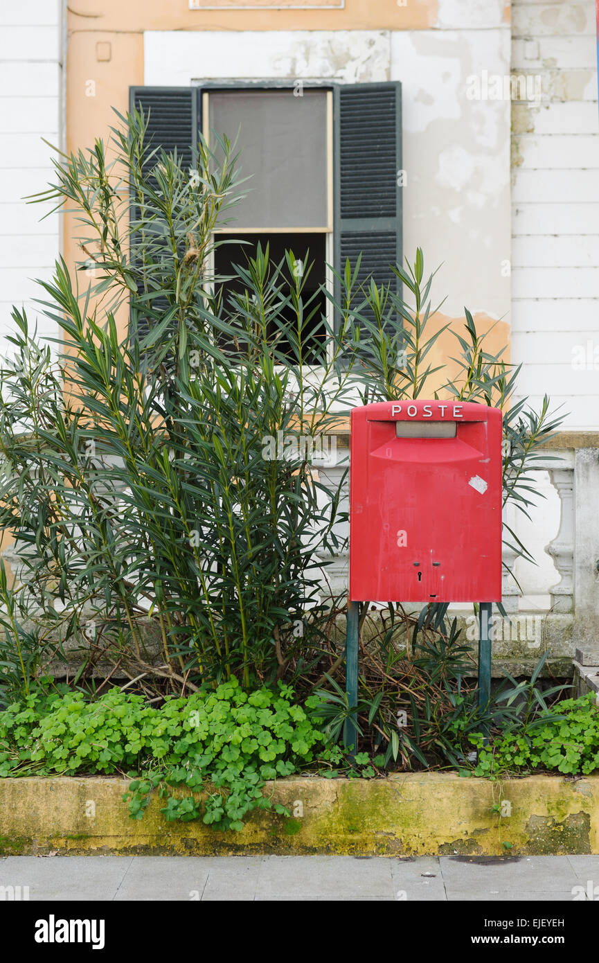 red postbox at the side of street in Italy. Stock Photo