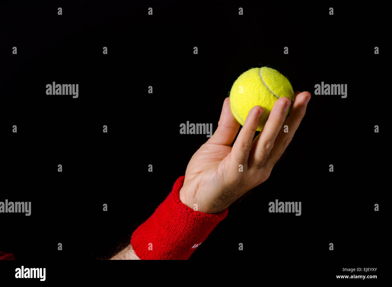 Closeup of man hand, arm, preparing to toss the tennis ball, performing