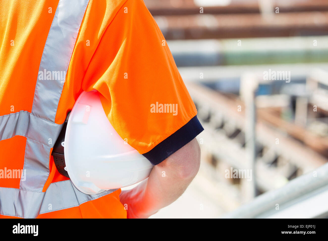 Man working at construction site, helmet Stock Photo