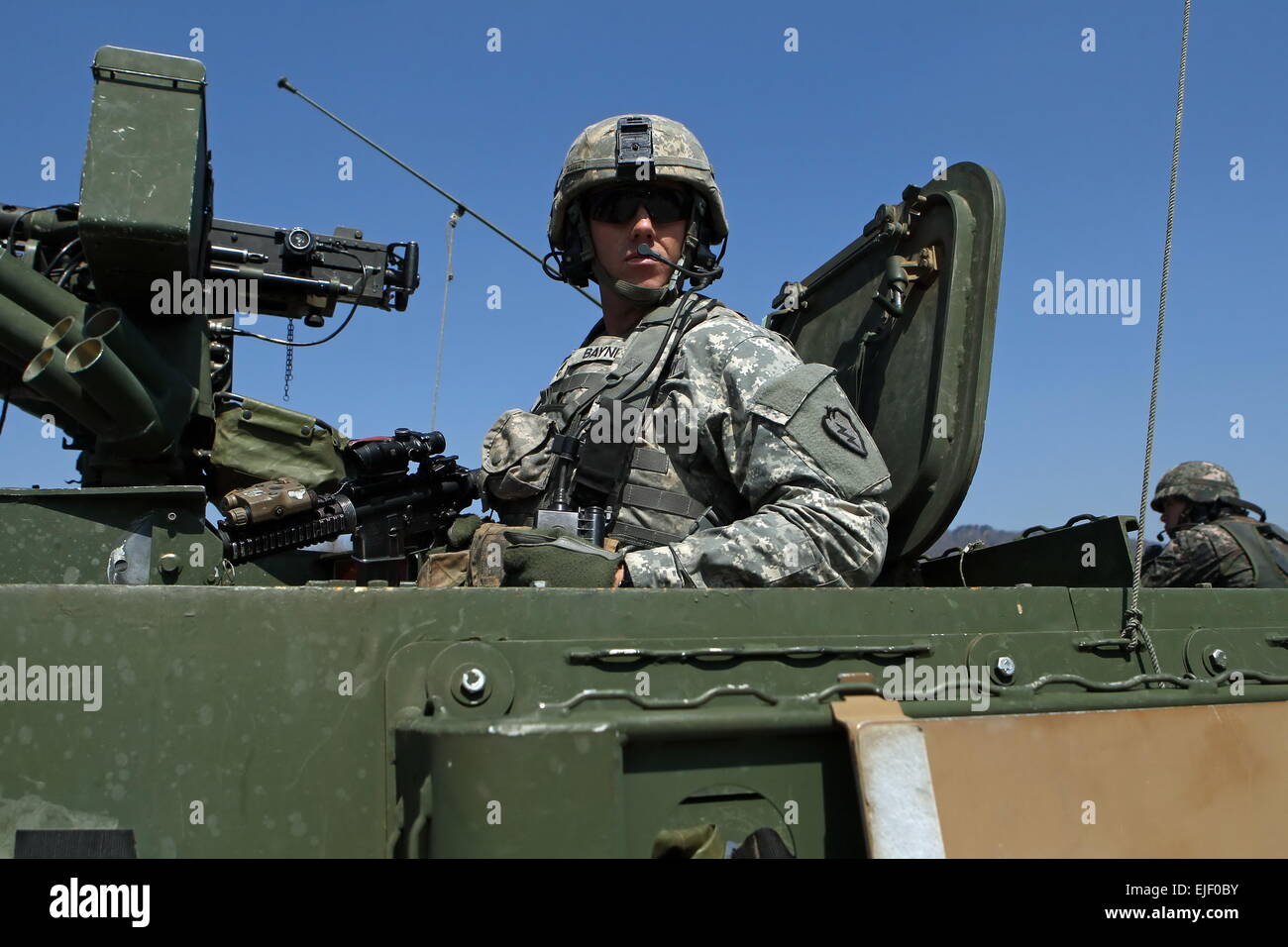 (150325) -- POCHEON, March 25, 2015 (Xinhua) -- An U.S. army soldier sits on top of an armored vehicle during the annual joint military exercise Foal Eagle between South Korea and the United States in Pocheon, northeast of Seoul, March 25, 2015. (Xinhua/Seongbin Kang) Stock Photo