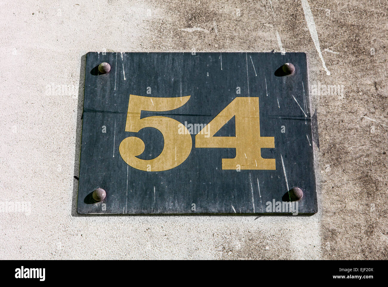 The Number 54 on a wall. Stock Photo