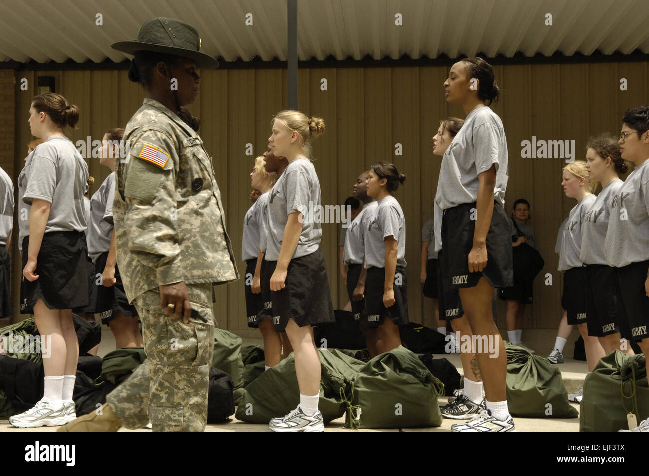 Female soldiers at basic combat training listen to instructions