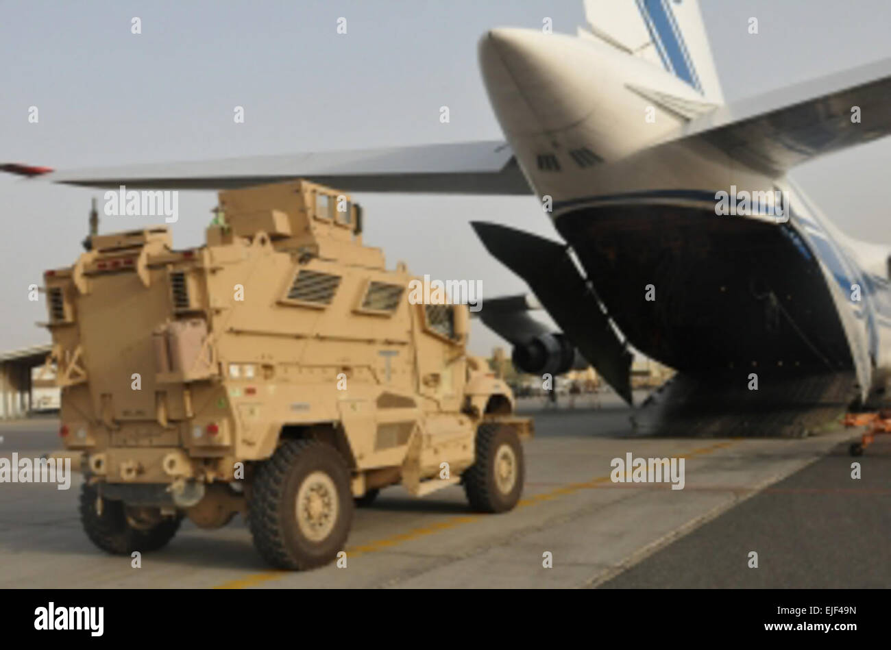 Mine Resistant Ambush Protected Maxx Pro vehicles are loaded onto a transport aircraft in support of the responsible drawdown of U.S. forces in Iraq. The 62nd Chemical Company provides the security for the vehicles throughout the flight.   Spc. Karen Kozub Stock Photo