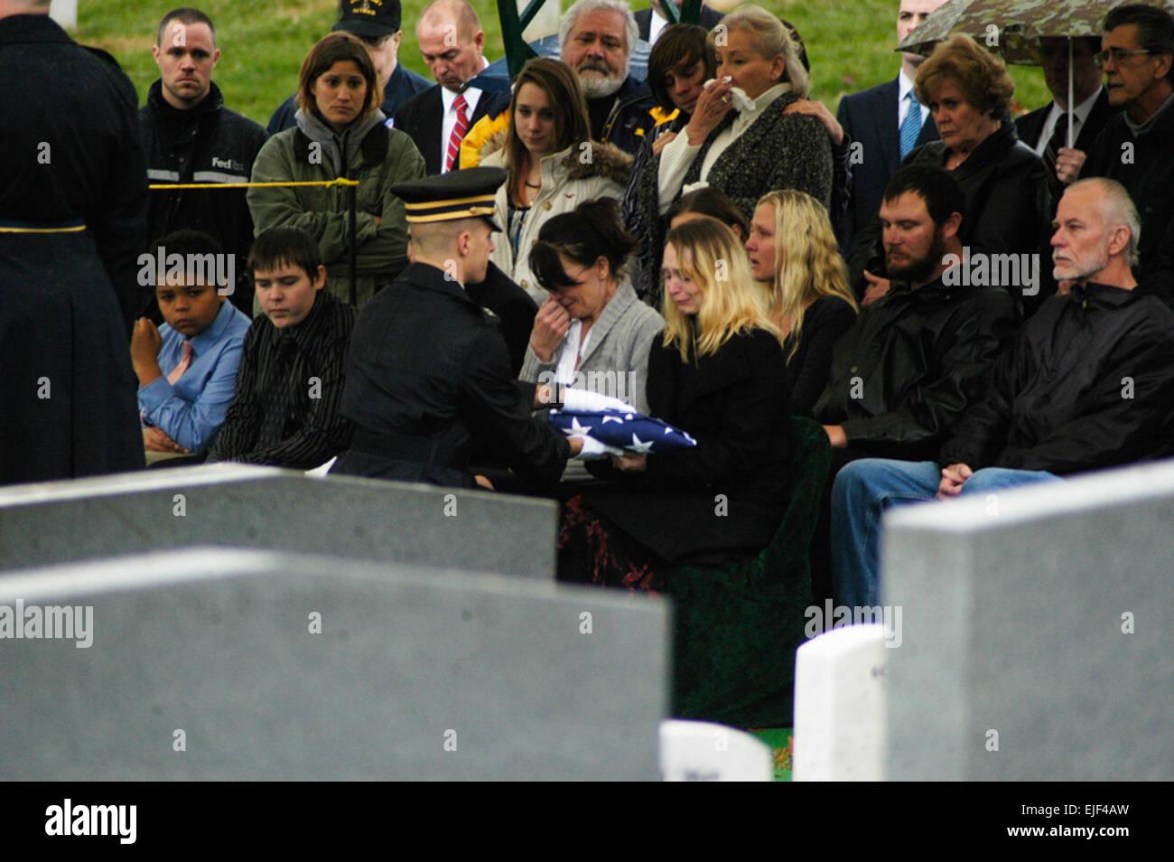 Chaplain Capt. Jason Nobles presents a flag to Nichole Siccardi, daughter of former Sgt. Leonard Keller, a Medal of Honor recipient who was buried at Arlington National Cemetery Monday, November 30, 2009.          Army buries Vietnam Medal of Honor recipient  /-news/2009/12/02/31216-army-buries-vietnam-medal-of-honor-recipient/ Stock Photo