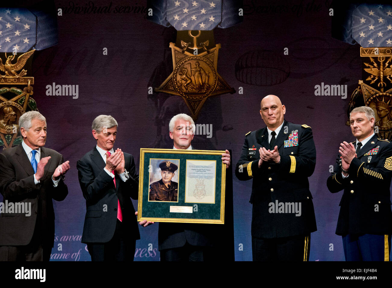 Defense Secretary Chuck Hagel, far left, applauds during a ceremony to induct Medal of Honor recipient Army Chaplain Capt. Emil Kapaun into the Hall of Heroes at the Pentagon, April 12, 2013. Ray Kapaun, the chaplain's nephew, represented his uncle, who served in the Korean War, during the ceremony. Army Secretary John M. McHugh, second from left, Army Chief of Staff Gen. Ray Odierno, second from right, and Sgt. Maj. of the Army Raymond F. Chandler III, far right, participated in the ceremony. DOD photo by Erin A. Kirk-Cuomo Stock Photo