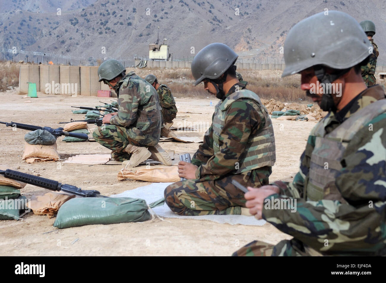 Afghan national army of the 6th Codec, 2nd Brigade, 201st Corp, 1st Company soldiers load ammunition into their magazines for a weapons qualification with the M16 A1 rifle on FOB Bostick at Bostick Afghanistan, Jan. 16. Stock Photo