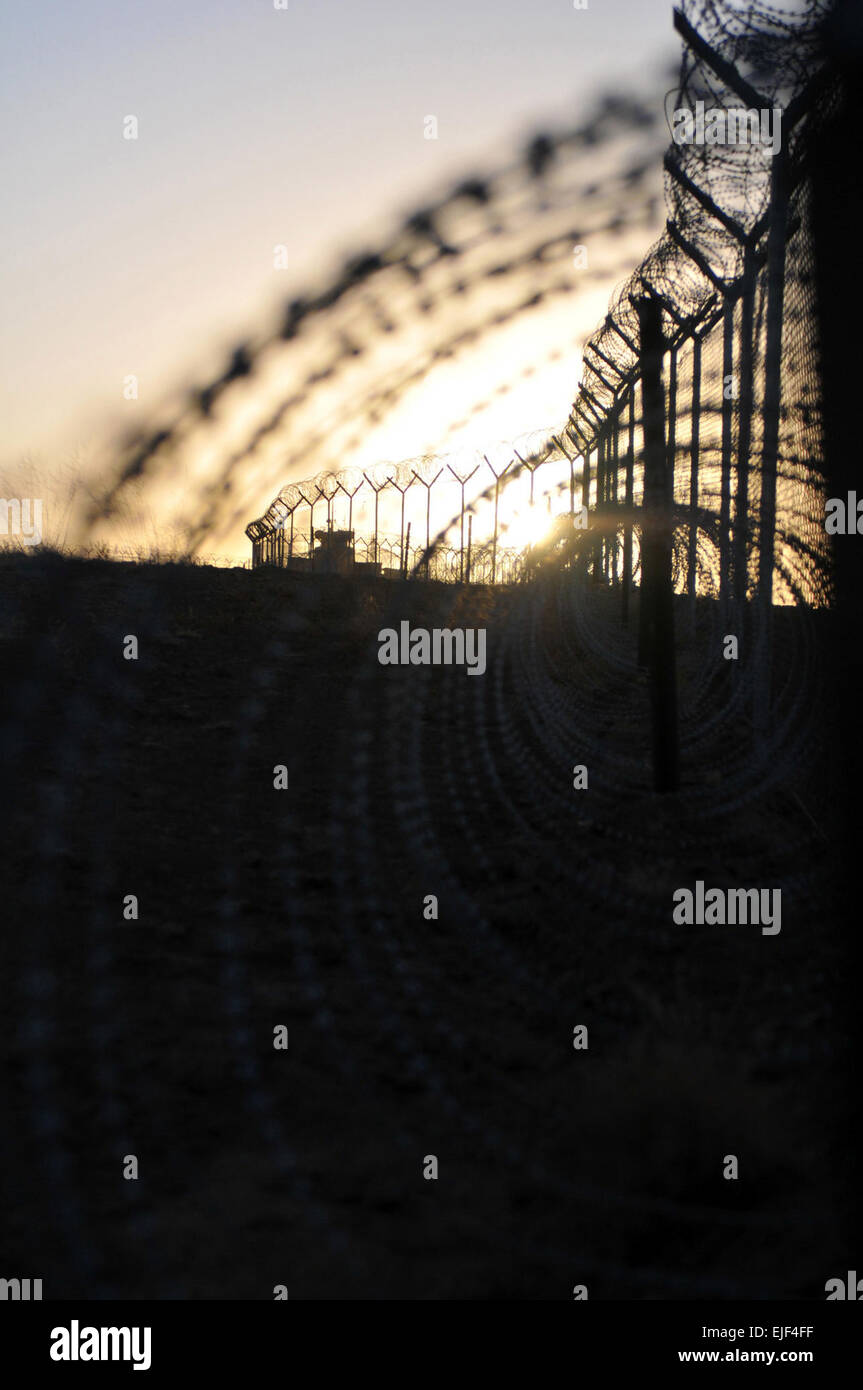 The sun rises along the outer boundary of Forward Operating Base Sharana, Afghanistan. Stock Photo